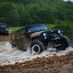 off-road vehicle crossing a jungle river