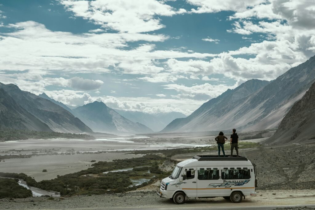 two-traveller-standing-on-caravan-rooftop-watching-valley-experiences-in-Ladakh