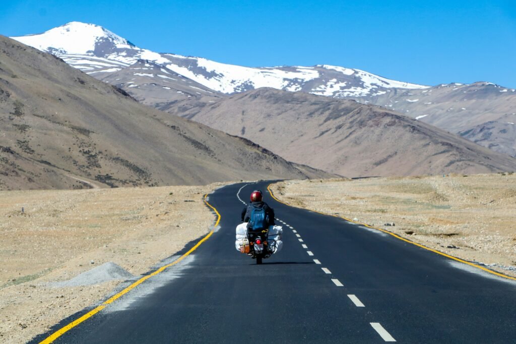 a-motorcylist-riding-in-valley-road-experiences-in-Ladakh