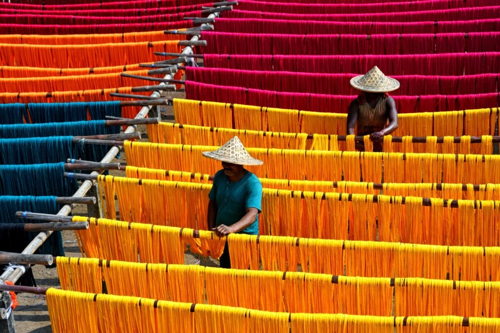 two weaver drying silk yarns