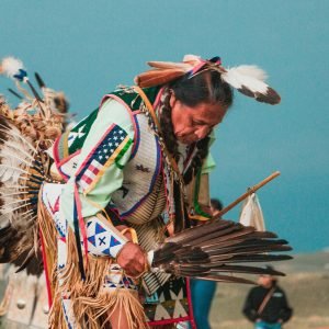 tribal-woman-wearing-feather-props-immersive-cultural-travel-experiences