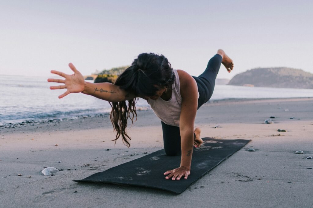 woman-practicing-yoga-asana-by-the-beach