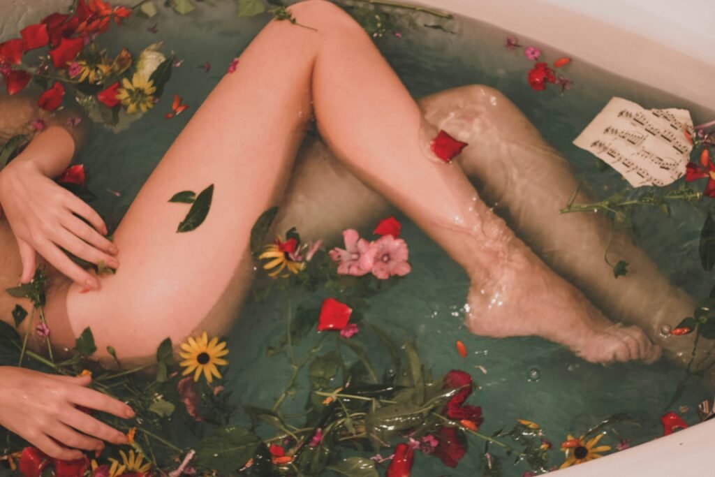 legs-submerged-in-bathtub-with-leaves-petals-wellness-travel-experiences
