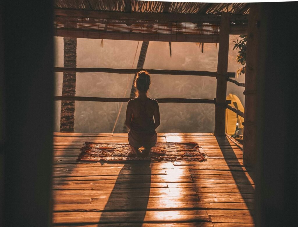 woman-facing-morning-sun-in-balcony-of-yoga-retreat-experience