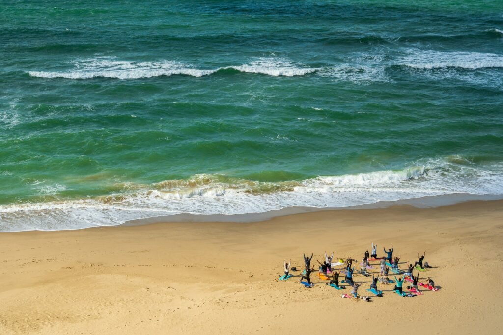 group-of-people-practicing-yoga-by-the-seaside-yoga-retreat-experience